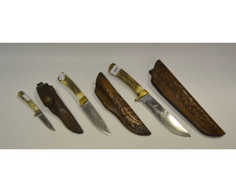 A horn handled, Sheffield steel made, hunting knife; others, leather scabbard (3)