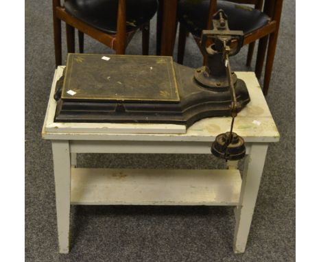 An early 20th Century set of weighing scales on a rectangular table