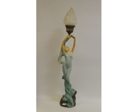 An Art Deco figural lamp, as a lady standing in flowing drapes holding a torch aloft