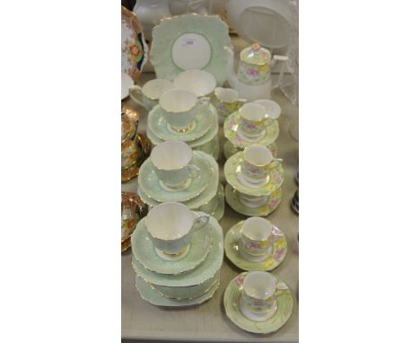 Teawares - a Bell china part tea service; a Bell china part coffee service flower finial flower border on an apple green grou