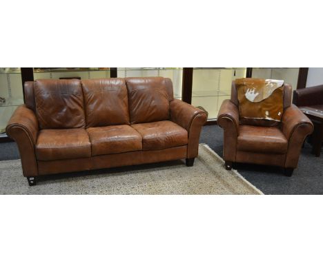 A contemporary tan leather three set sofa; a conforming armchair (2)