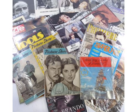 A collection of Marlon Brando film memorabilia, including campaign book, lobby cards, press photos and Vintage film magazines