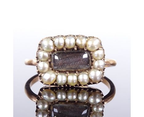An unmarked gold split pearl hair panel memorial ring, setting height 11.4mm, size Q, 4.3gGood overall condition although pie