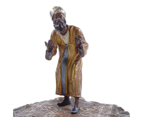 A large cold painted metal sculpture of an Arab carpet seller, stamped made in Austria, height 18cm 