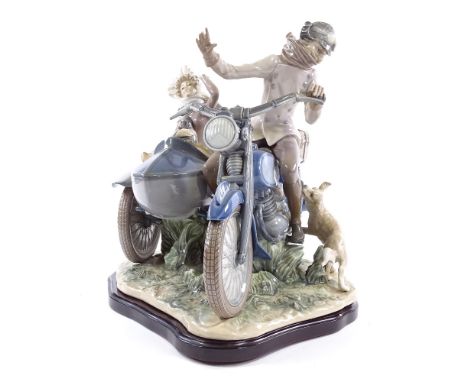 A large Lladro ceramic group, motorcycle and sidecar riders, 1982 - 1985, on wooden display base, length 40cm, height 37cm&nb