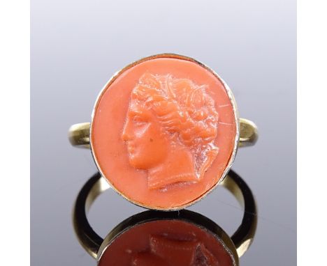 A silver-gilt relief carved coral panel ring, depicting Classical portrait, setting height 15.1mm, size M, 2.8gVery good over