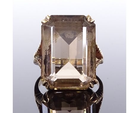 A 9ct gold smoky quartz tablet ring, ribbed shoulders and bridge, maker's marks MJ, hallmarks Birmingham 1965, setting height