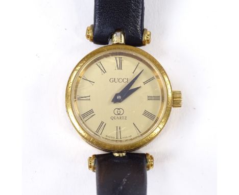 GUCCI - a lady's Vintage gold plated quartz wristwatch, champagne dial with Roman numeral hour markers and enamelled case, 4 