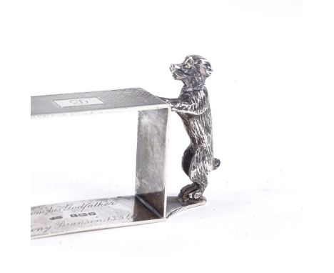 A George V novelty silver standing dog rectangular napkin ring, engine turned decoration, by Sanders & Mackenzie, hallmarks B