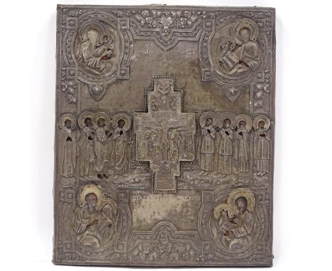 A Russian silver-fronted icon, 18th or 19th century, relief moulded figures of the saints with Cyrillic inscriptions and inse