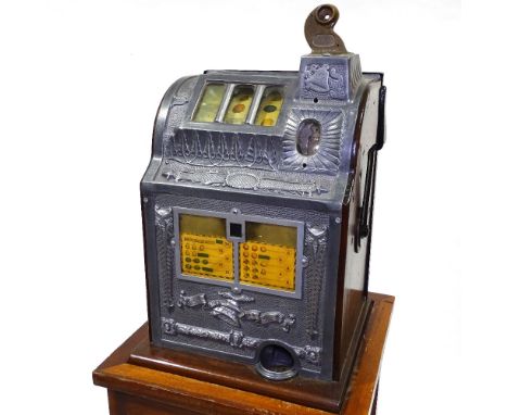 An American Bell Fruit coin-in-the-slot fruit machine, circa 1930, mahogany and cast-aluminium case, width 13.5", height 19.5