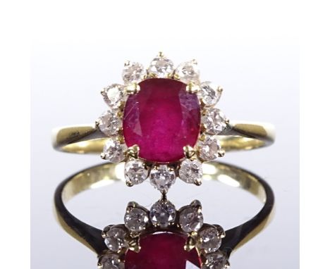 An 18ct gold ruby and diamond cluster ring, total diamond content approx 0.2ct, setting height 10.8mm, size M, 2.3gVery good 