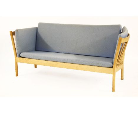 A Danish beech stick back settee,with blue upholstery, 185cm wide