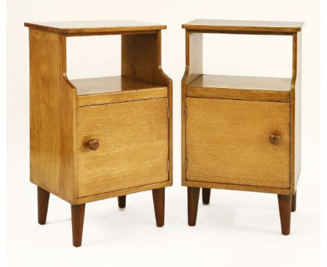 A pair of oak bedside cupboards,with a shelf over a cupboard, labelled 'Russell of Broadway',43cm wide33cm deep73.5cm high (2