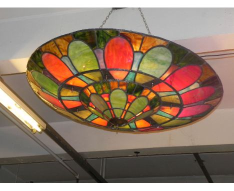 A pair of circular Art Deco design ceiling lights,each with coloured leaded glass panels, with light fittings including fluor