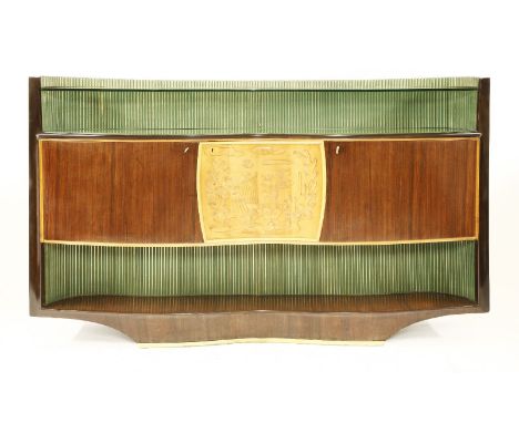 An Italian rosewood sideboard,by Dassi, 1950s, of serpentine form with a glass shelf and a reeded panel back, the central cup