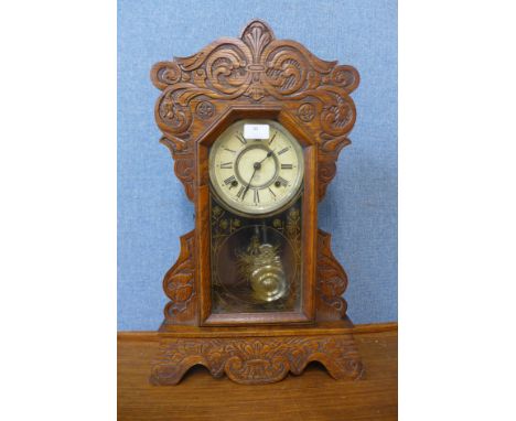 A 19th Century American carved beech gingerbread shelf clock by Ansonia Clock Co. 