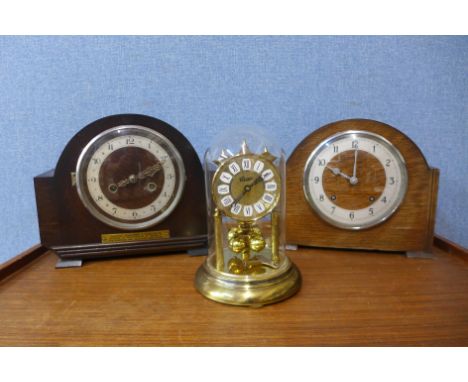 Two oak mantel clocks and a brass anniversary clock 