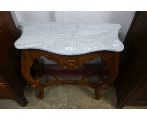 A small rococo style mahogany and marble topped console table 