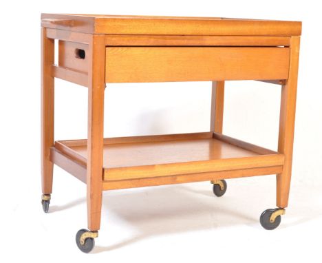 A retro vintage circa 1960s teak wood&nbsp; two tier drinks / cocktail trolley having a cutlery drawer to the top raised on s