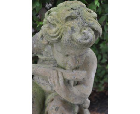 A large late 20th century salvage yard composite garden statue is depicting a&nbsp;Cherub on finial with flute. The large sta