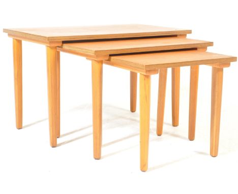 A vintage retro mid 20th century Danish inspired teak wood nest of tables. The three graduated tables having a rectangular to