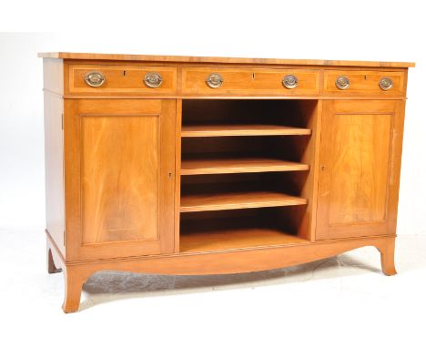 A&nbsp; 20th century George III revival mahogany open front sideboard credenza being raised on bracket feet with end cupboard
