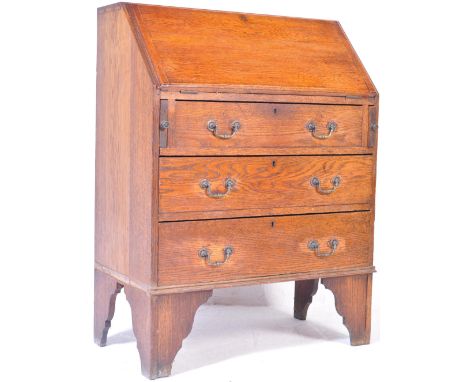 An Edwardian honey oak bureau office desk. Raised on bracket feet with a bank of 3 drawers having swing handles beneath fall 