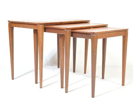 A retro vintage mid 20th century Danish inspired teak wood&nbsp;nest of graduating tables of rectangular form raised on taper