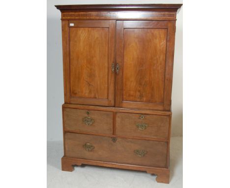 An 18th century George III mahogany linen press. Raised on ogee bracket feet with short and deep drawer configuration having 