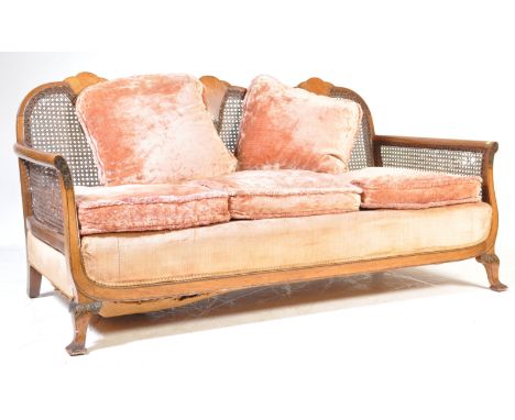 A 1930's early 20th century walnut Queen Anne revival bergere caned sofa settee. Raised on cabriole legs with ball and claw f