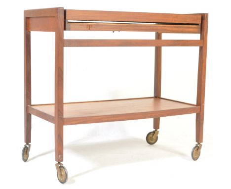 A retro vintage circa 1960s teak wood trolley having two tiers with drop leaves raised on square supports &amp; castors. Meas