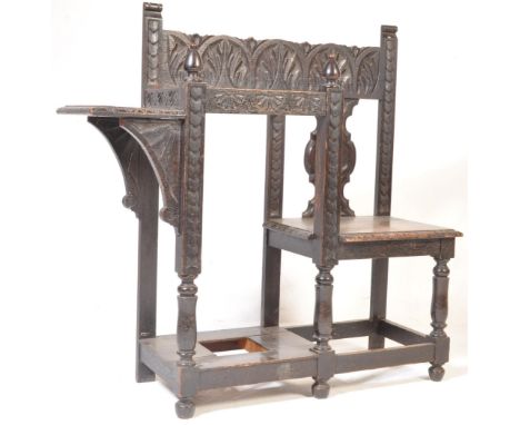 A 19th Century Victorian oak hallstand having a carved back panel with seat to one side and a stick stand to the left raised 