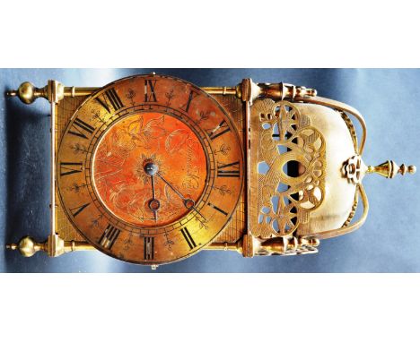 An 18th century George III style brass mantel clock / lantern clock marked Thomas Mudge. The lantern clock having a large cir