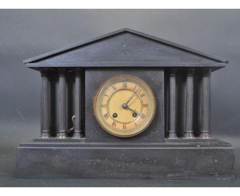 A 19th century Victorian 8 day slate and marble mantel clock of architectural form having brass dial with Roman numerals to t