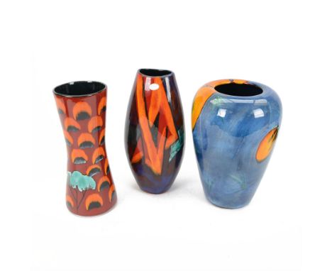 Three Poole pottery vases, one of baluster form in Wild Poppy pattern, two in red and green tones