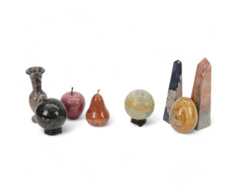 Two polished hardstone obelisks, together with other polished hardstone including egg, spheres, apple, pear and vase, tallest