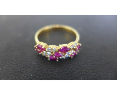 An 18ct yellow gold ring with rubies and diamonds to shoulder, seven rubies and twelve small diamonds, size R - approx weight