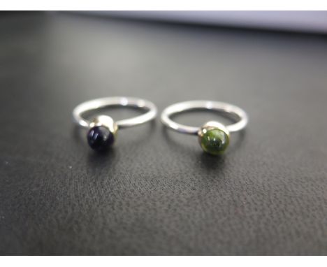 A pair of cabochon rings - To include amethyst and peridot - With marks indicating silver - Ring sizes K 1/2 and L - Total we