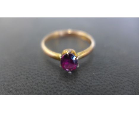 A 9ct rose gold dress ring with garnet coloured stone to shoulder, ring size R, approx weight 2 grams - in good condition