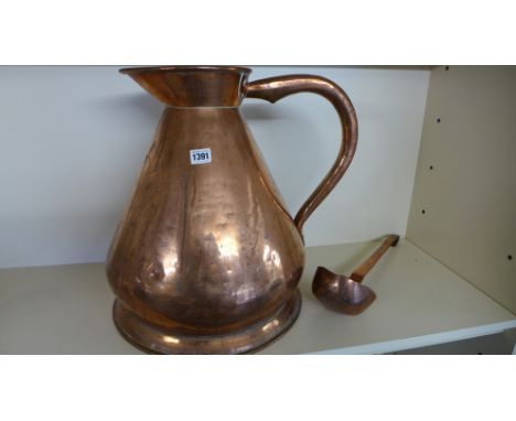 A large copper jug with dovetail seam and a ladle - Height 46cm 
Condition report: Some denting but generally good 