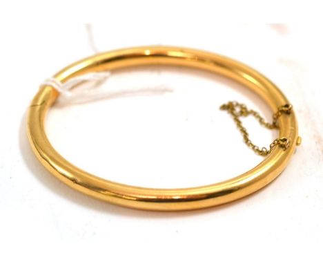 A hinge opening bangleThe bangle is not hallmarked or stamped but in our opinion would test as gold. 10.6g