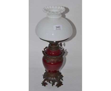 A 19th century metal mounted oil lamp with opaque shade 