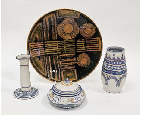 Poole Studio mid-century charger decorated in orange and green glazes with abstract flowerheads, banding and geometric orname