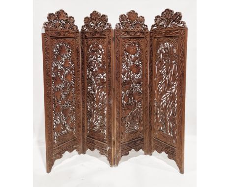 Anglo-Indian hardwood four-fold dressing screen, each panel with pierced and blind fretwork carved decoration of bullrushes a