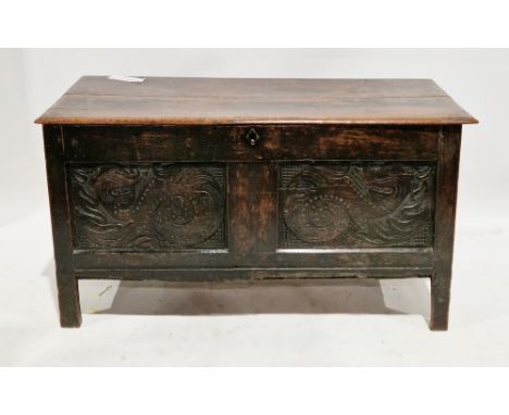 17th/18th century oak coffer, the hinged rectangular two-plank top with thumbmould edge, over two front panels carved with a 