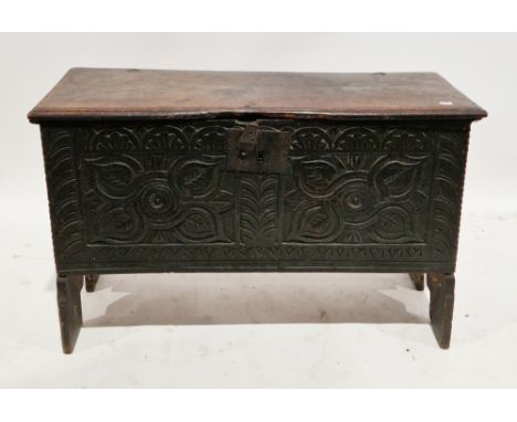 17th century oak six-plank coffer, the rectangular top with thumbmould edge over a later carved front panel, iron lock, on V-