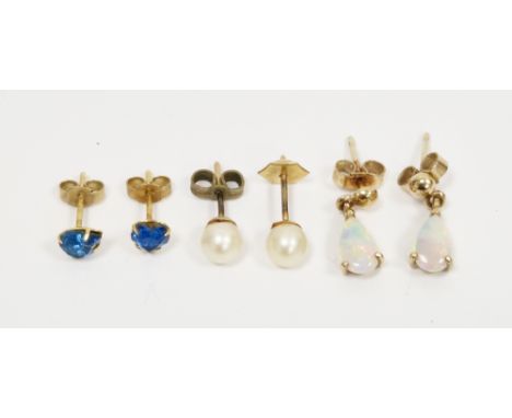 Pair of 9ct yellow gold and white opal drop earrings, each earring set with a pear shaped cabochon opal, with butterfly faste