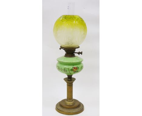 Victorian oil lamp having a green tinted etched glass shade, a green glass well with floral painted decoration, on a brass co
