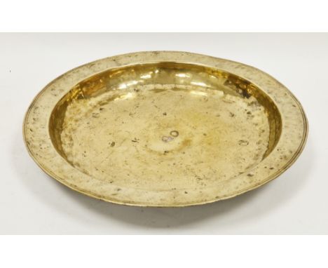 German or Dutch brass charger, 18th century, of deep form with broad rim (small hole to rim), 37 cm diam.  